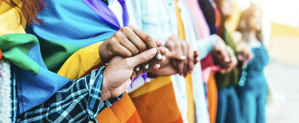 Group of lgbt people holding hands outside